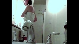 a girl in the bathroom washing clothes and swimming with a hidden camera